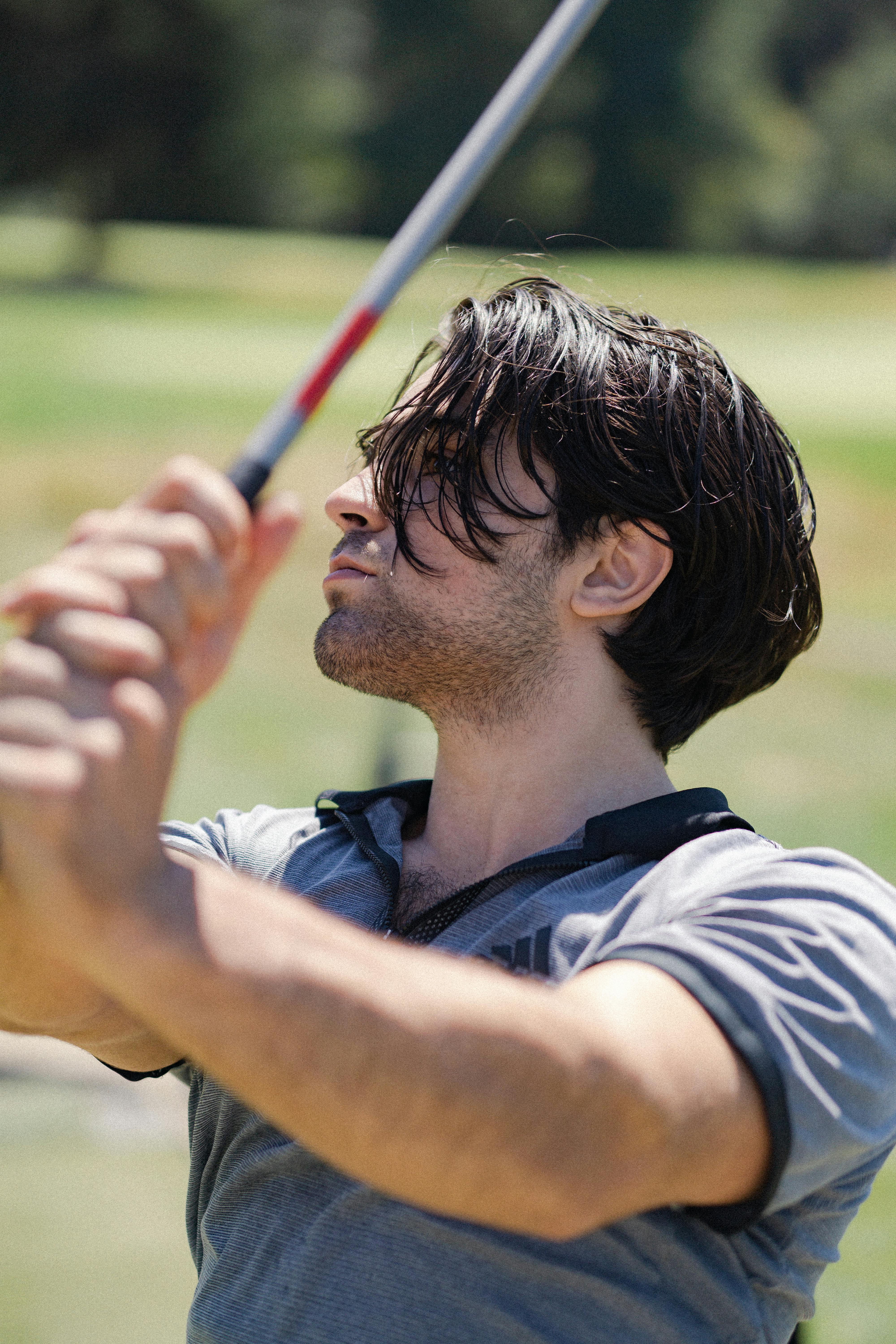 man playing golf on a field