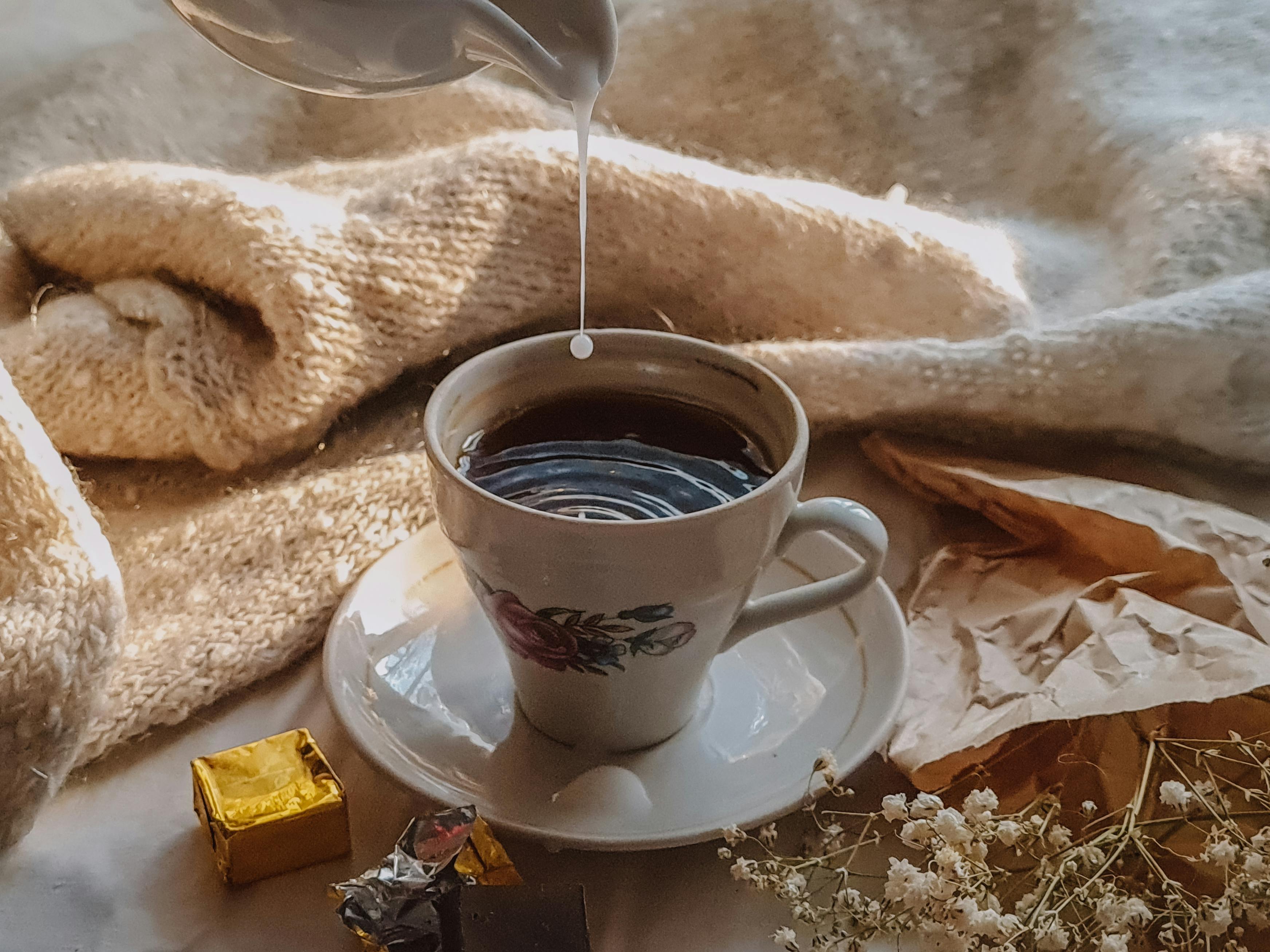 white ceramic cup with black liquid