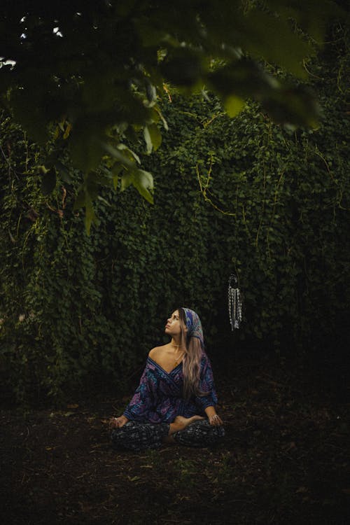 Woman Sitting on the Ground and Mediating 