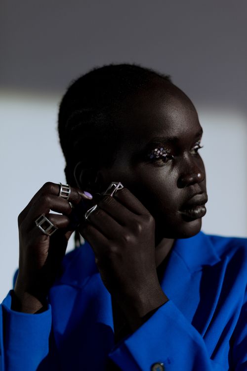 Model wearing sculptural silver rings, photographed by cottonbro studio on Pexels