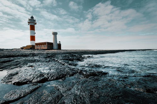 Red and White Lighthouse on Land