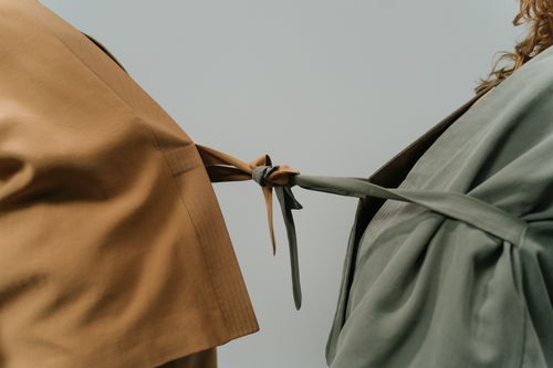 Free Close-up of two blazers tied together representing connection and unity. Stock Photo