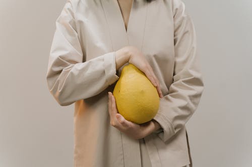 Unrecognizable Person Holding a Pomelo Fruit