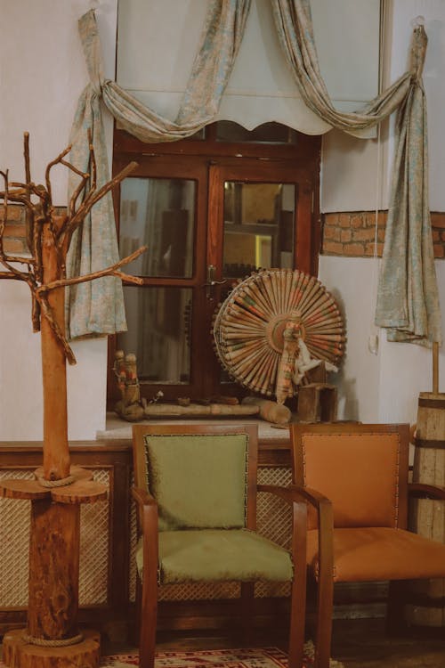 Wooden Armchairs Near a Window