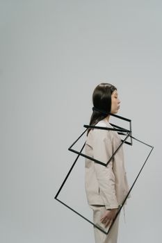 Side view of an Asian woman with black frames, offering a minimalist conceptual aesthetic.