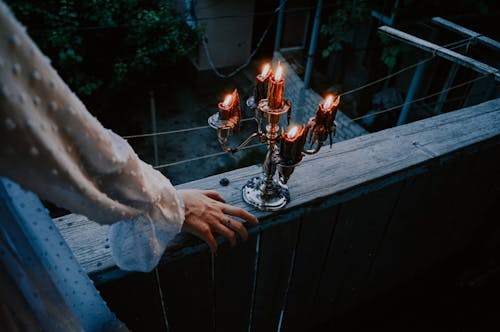 Person Holding Silver Round Bowl With Fire