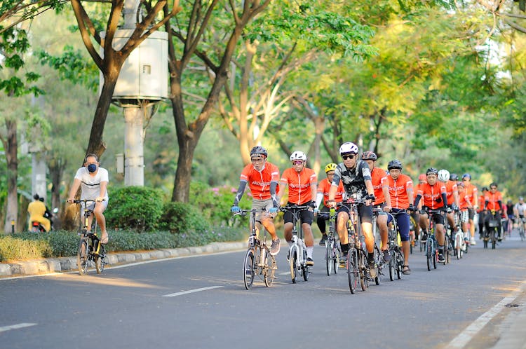 People Riding Bicycles On Road