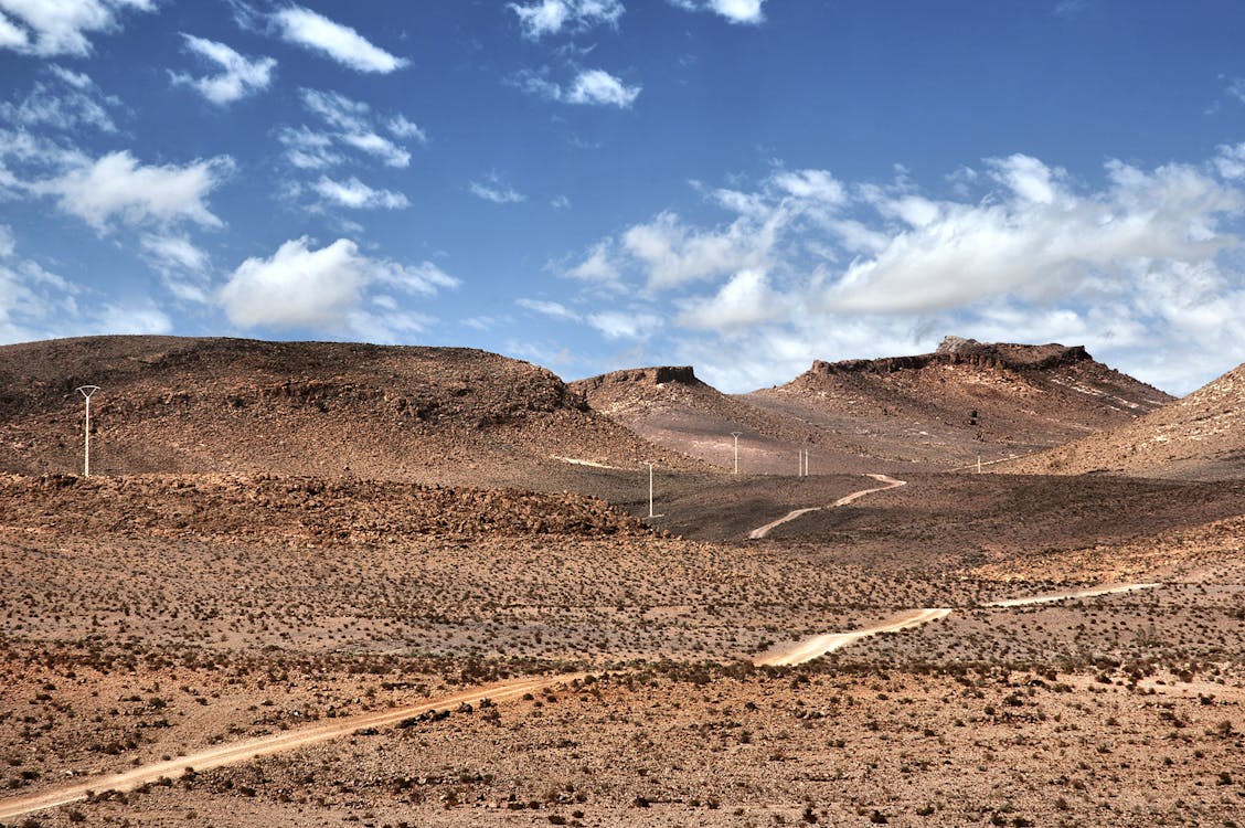 Dry and Rocky Landscape Under Blue Sky