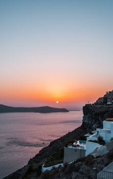 Breathtaking sunset over Santorini's coastline and architecture, capturing serene beauty.