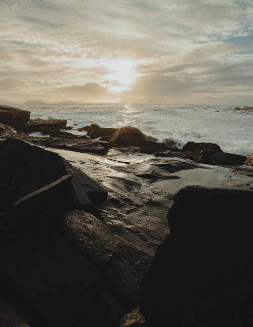 Rocky Shore Under Cloudy Sky