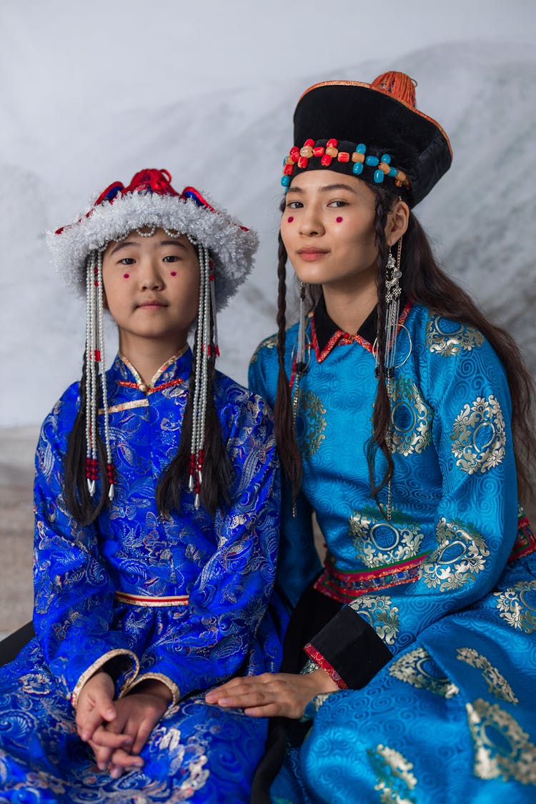 A Mother And Daughter Wearing Traditional Clothing