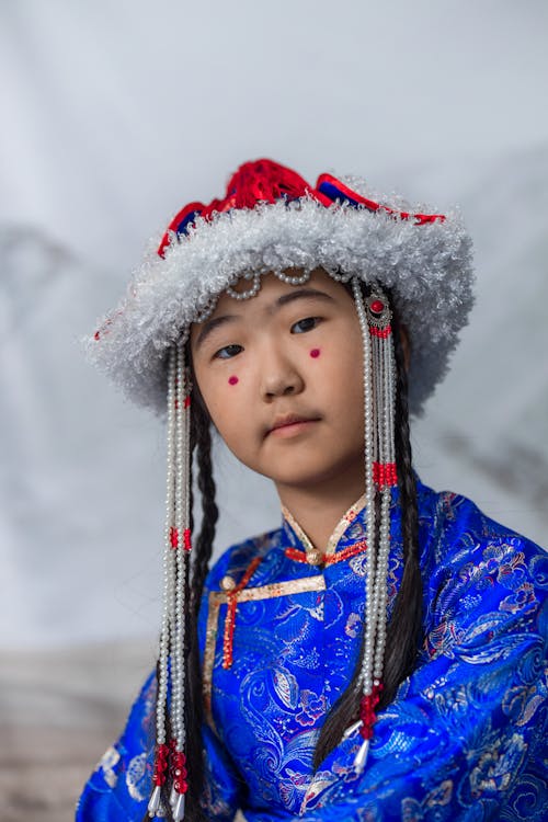 A Girl with Red Spots on Cheeks Wearing a Traditional Dress and a Pearl ...