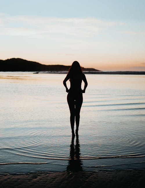 Silhouette of Woman Standing on Water