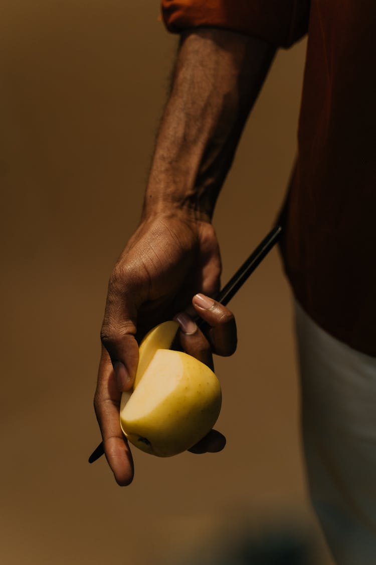 Person Holding An Apple Fruit