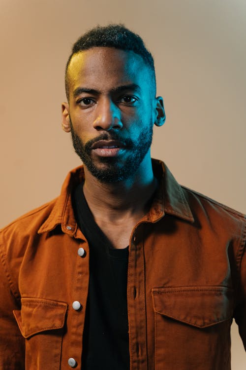 A Man Wearing a Brown Jacket over a Black Shirt