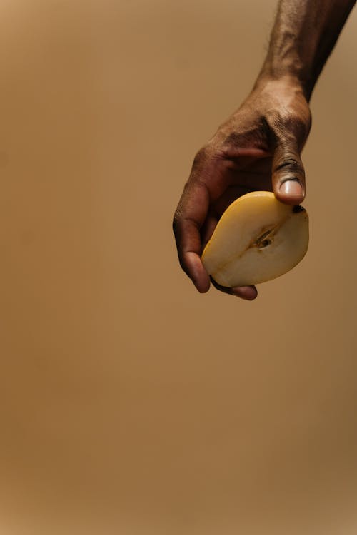 Free Hand Holding a Sliced Pear Stock Photo