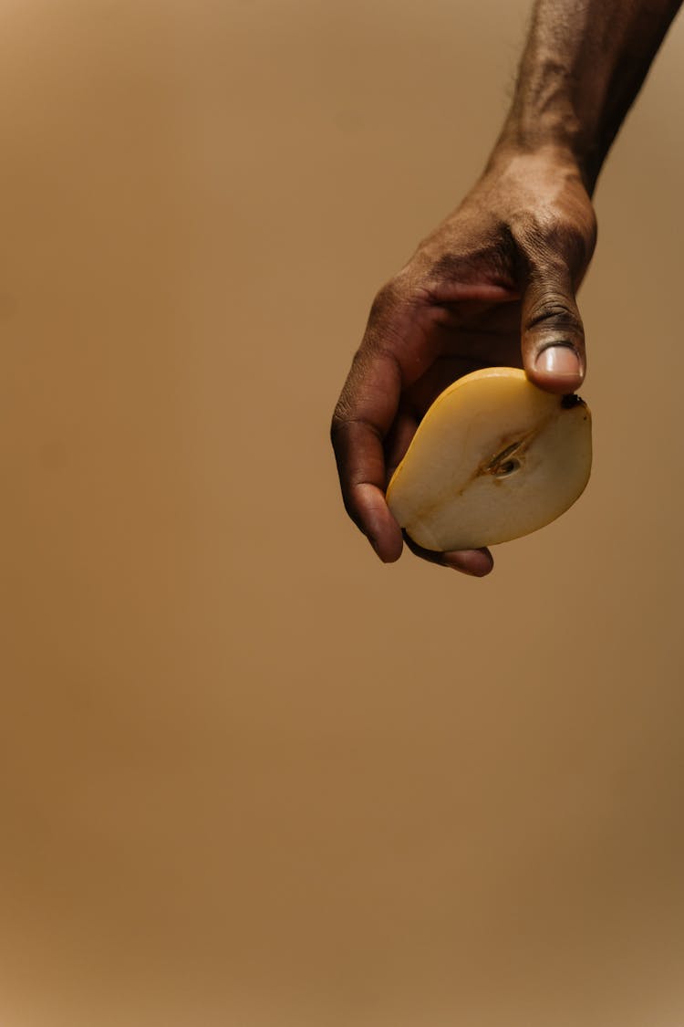 Hand Holding A Sliced Pear