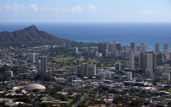 Photo by Michael Rocha Aerial view of Honolulu cityscape with Diamond Head and Pacific Ocean in the background.