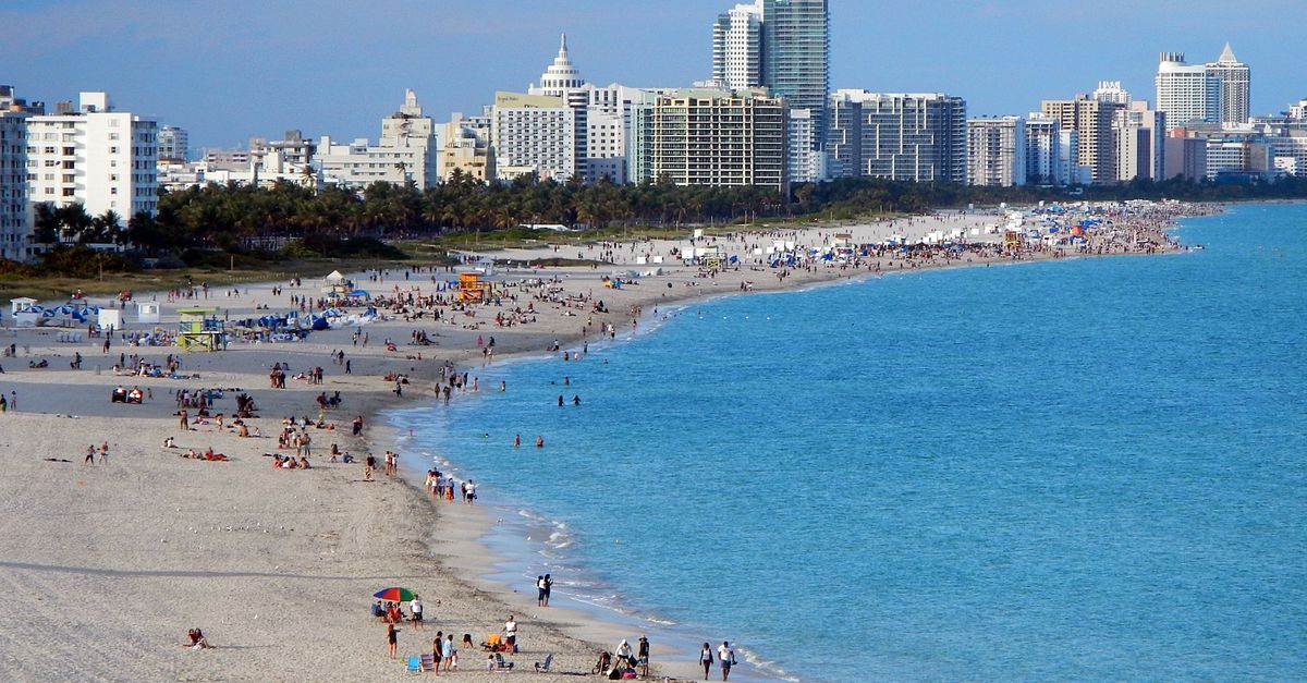 A vibrant beach scene with Miami's skyline backdrop, ideal for urban tourism imagery.