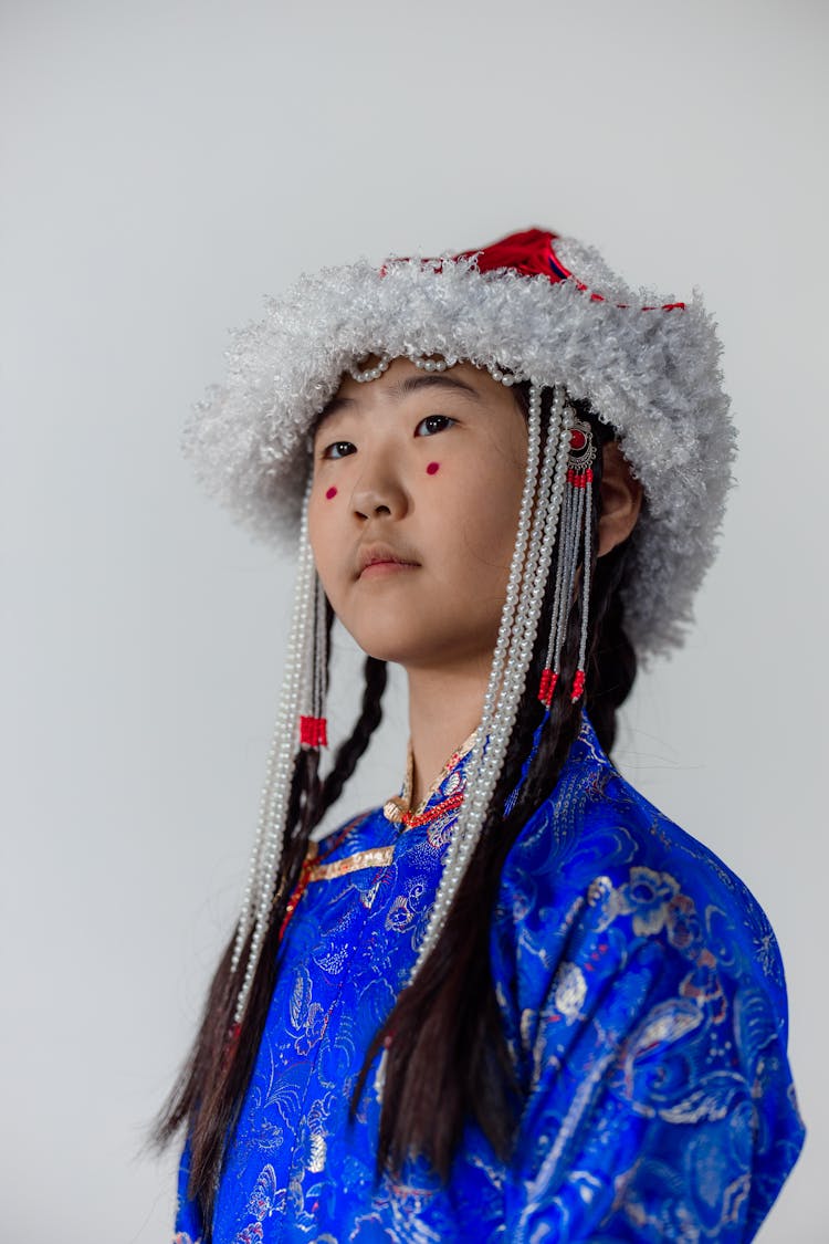 A Girl With Red Dots On Face Wearing Traditional Clothes