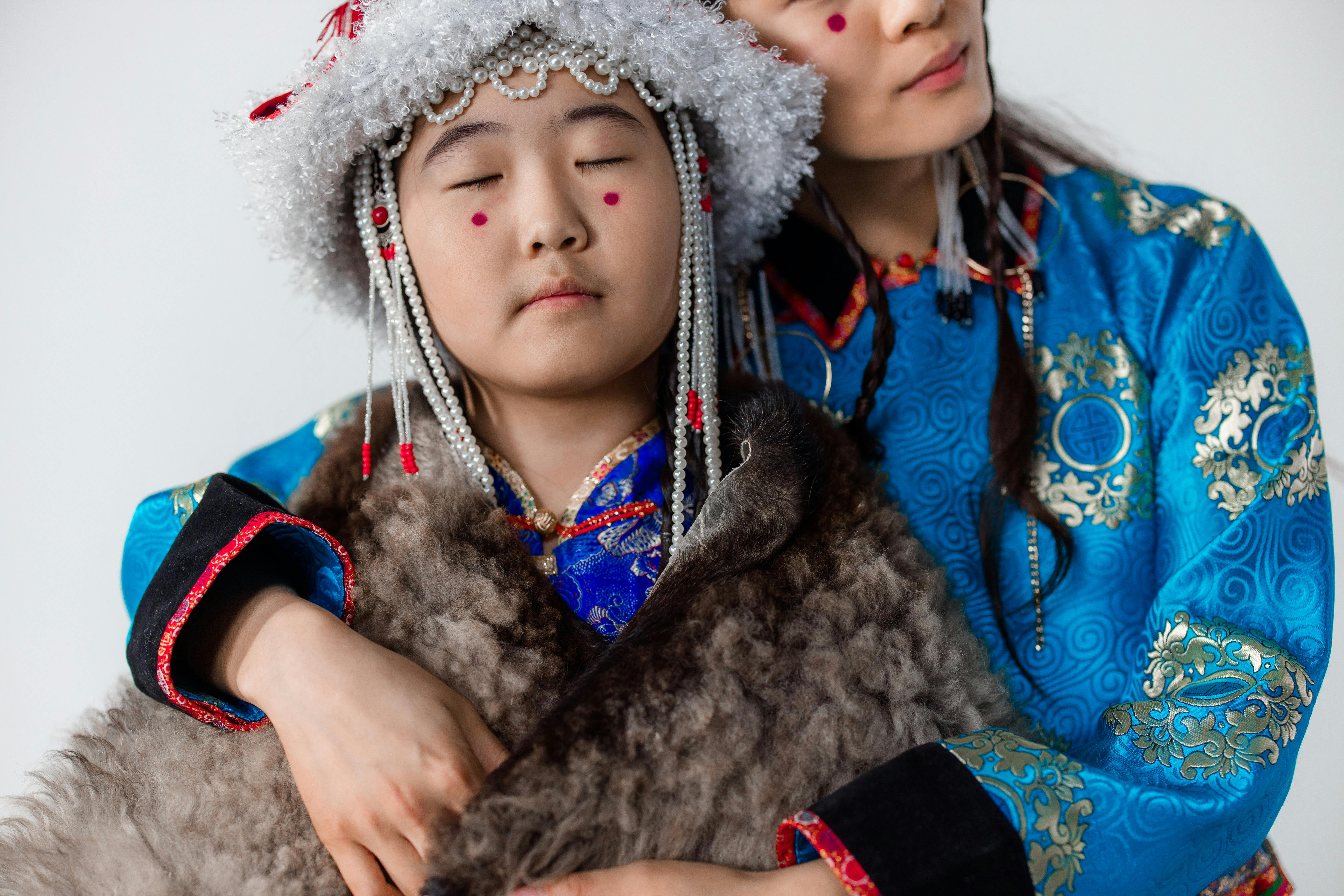 a girl in traditional clothes with her eyes closed