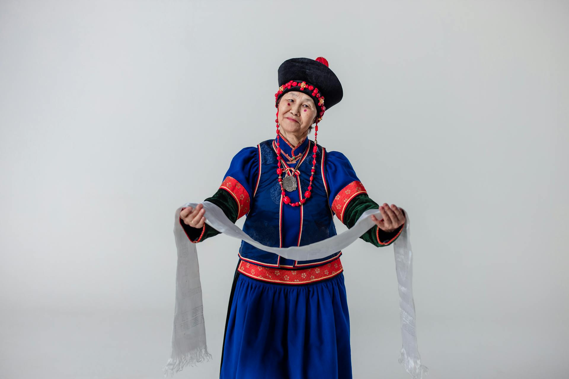 An Elderly Woman with Red Spots on Cheeks Wearing a Traditional Dress