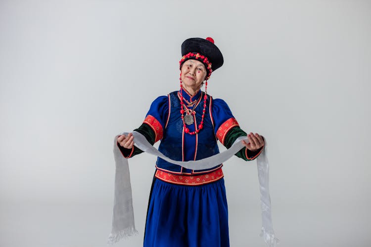 An Elderly Woman With Red Spots On Cheeks Wearing A Traditional Dress