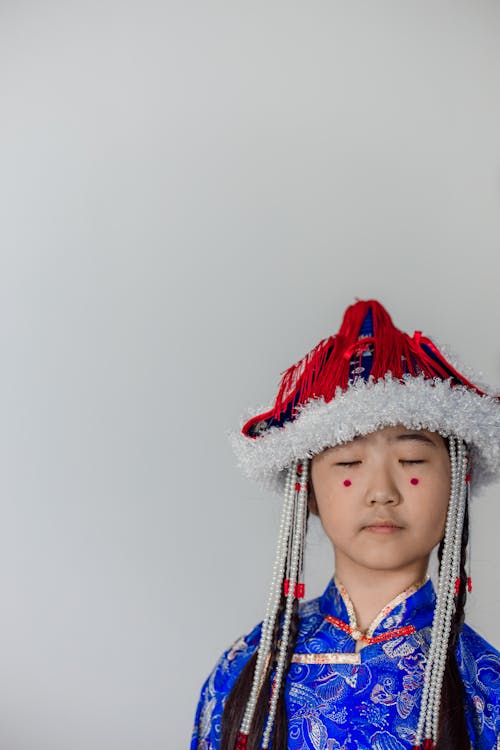 A Girl Wearing Traditional Clothes with Her Eyes Closed