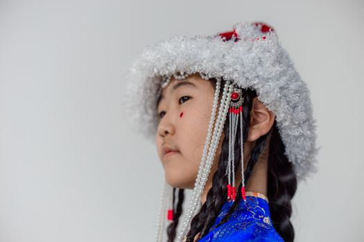 Woman in Blue and White Floral Shirt Wearing White and Red Fur Hat