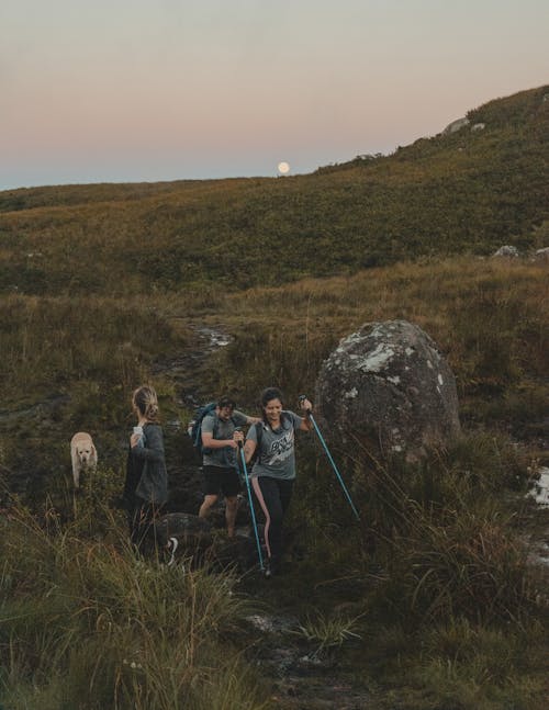 A Man and a Woman Walking on a Rocky Trail