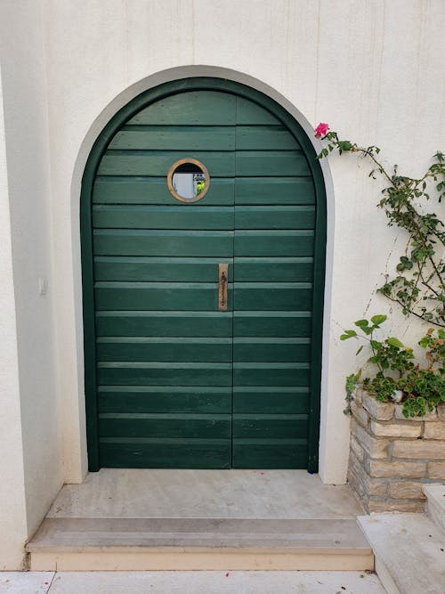 Free An Arched Wooden Door with Green Color Stock Photo