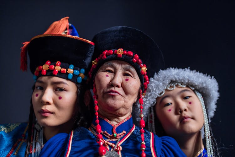 Elderly Woman Between A Woman And A Child Wearing  Mongolian Hats