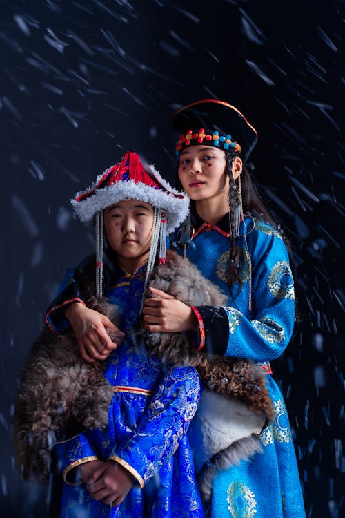 Snow Falling on Mother and Daughter Wearing Traditional Clothes