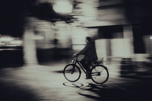 Free Grayscale Photo of Man Riding a Bicycle Stock Photo