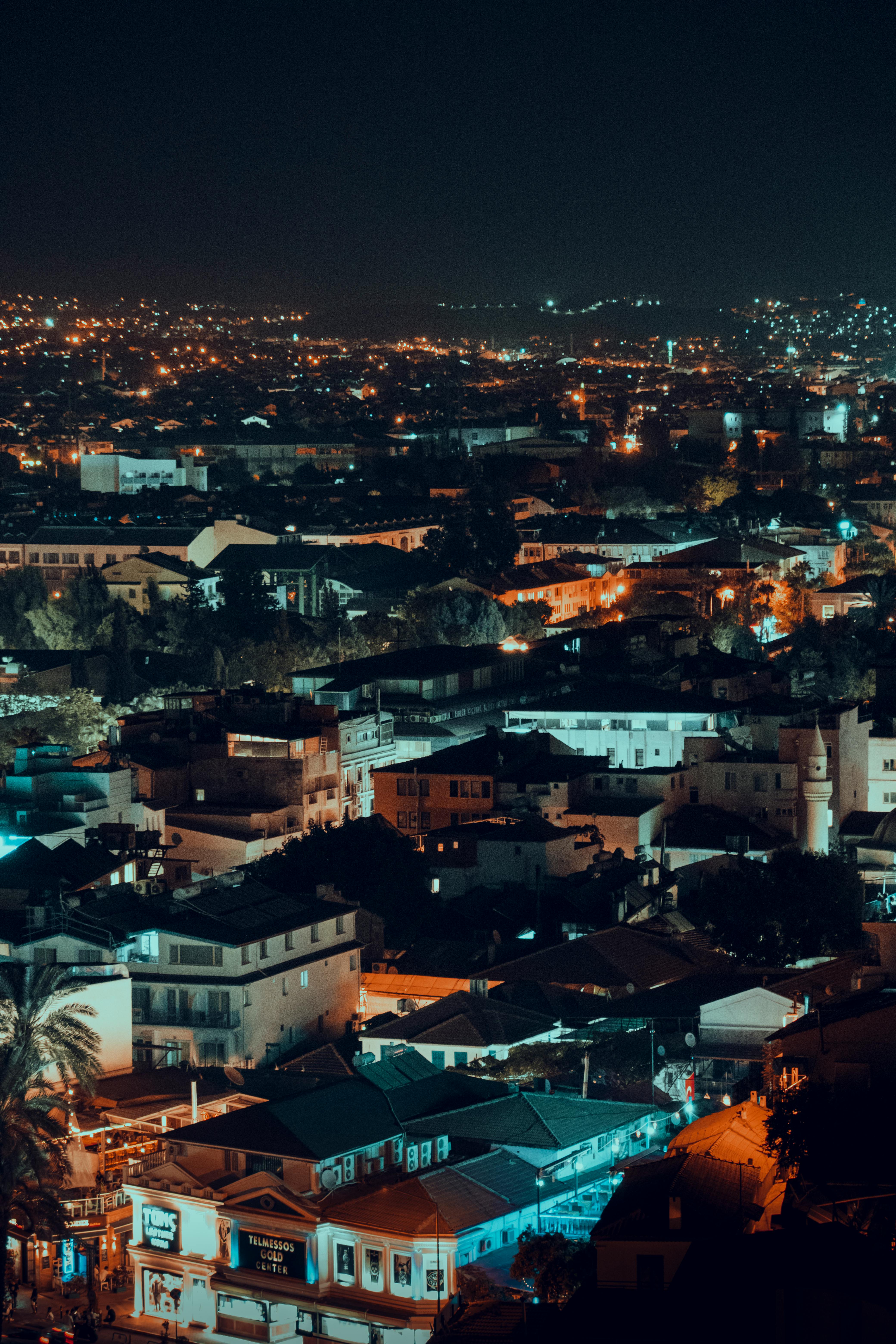 Captivating aerial view of a city lit up at night, showcasing its vibrant skyline and architecture.