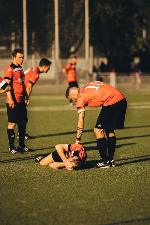 Free An injured Player Lying on the Ground Stock Photo