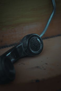 Nostalgic close-up of a vintage phone receiver, perfect for retro themes.