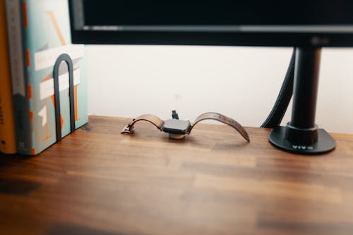 A Smartwatch on Wooden Desk