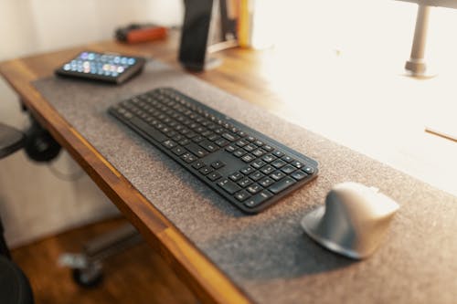 Black Computer Keyboard on Brown Wooden Table