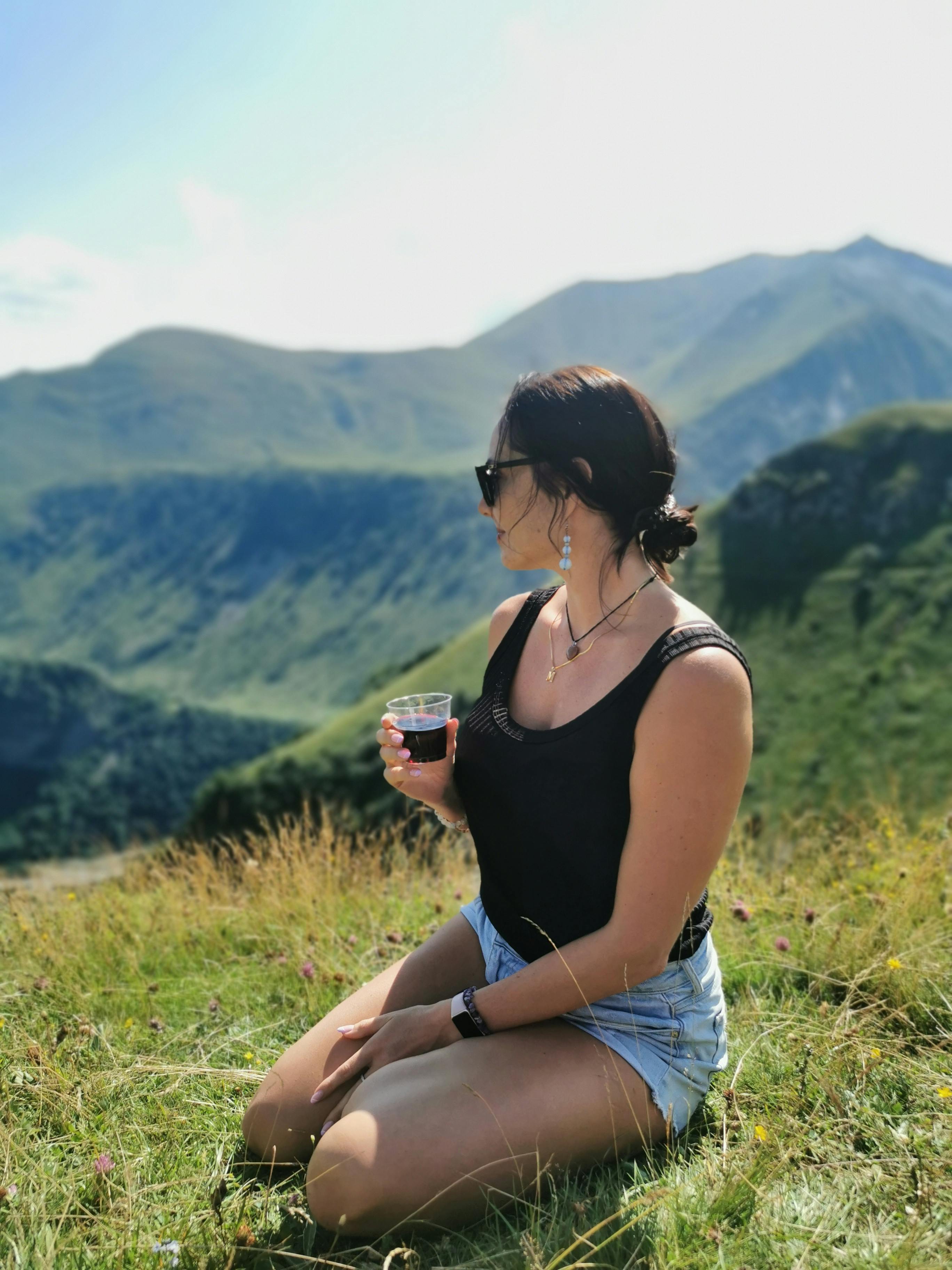 A woman enjoys a scenic view in the Mtskheta-Mtianeti mountains, Georgia.