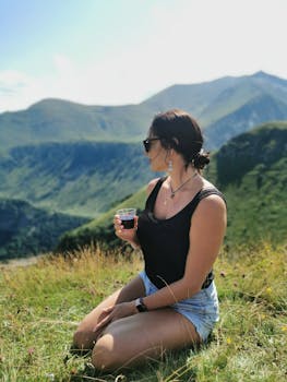 A woman enjoys a scenic view in the Mtskheta-Mtianeti mountains, Georgia.