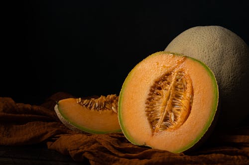 Close-up Photo of Melons on Dark Background