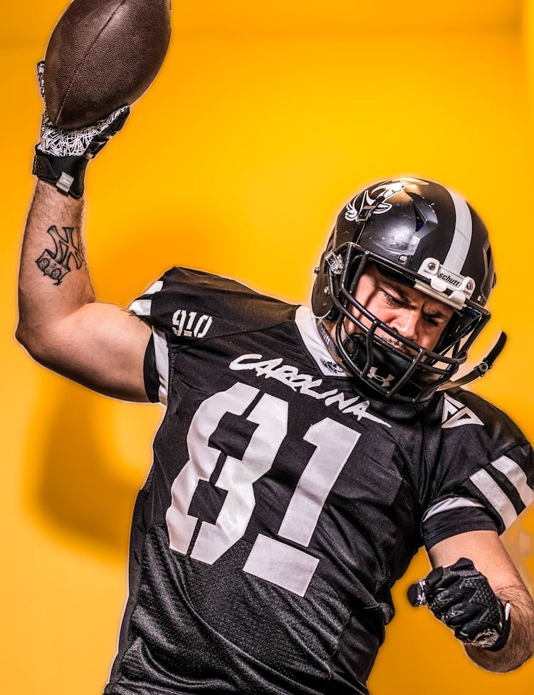 A Football Player With Yellow Background 