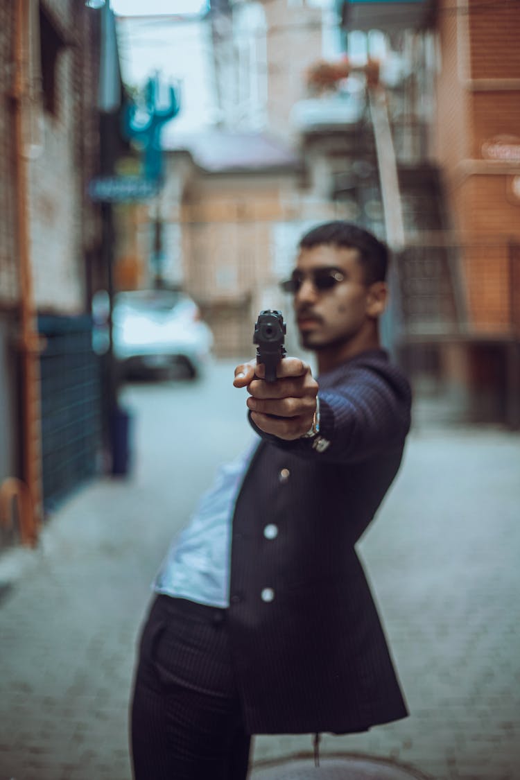 A Man Pointing A Gun