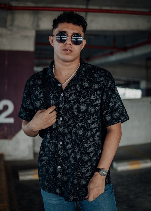 Free Photo of a Man in a Black Floral Polo Wearing Black Sunglasses Stock Photo