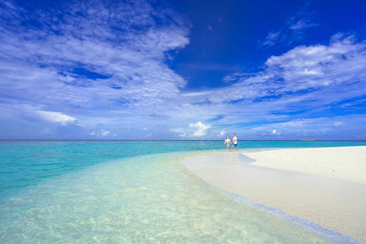 A Couple Walking On Beach