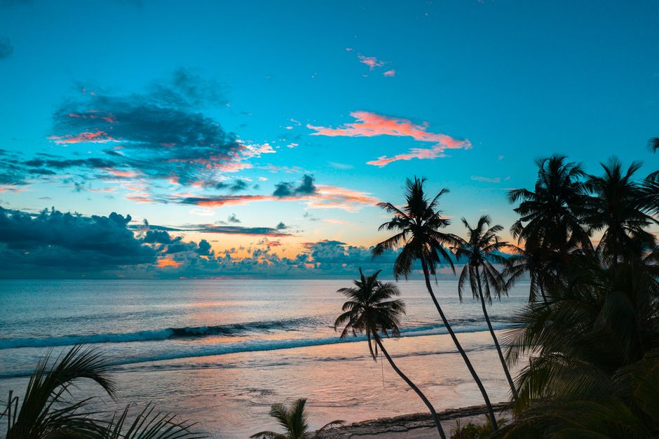 A beautiful tropical beach sunset in the Bahamas with calm ocean waves