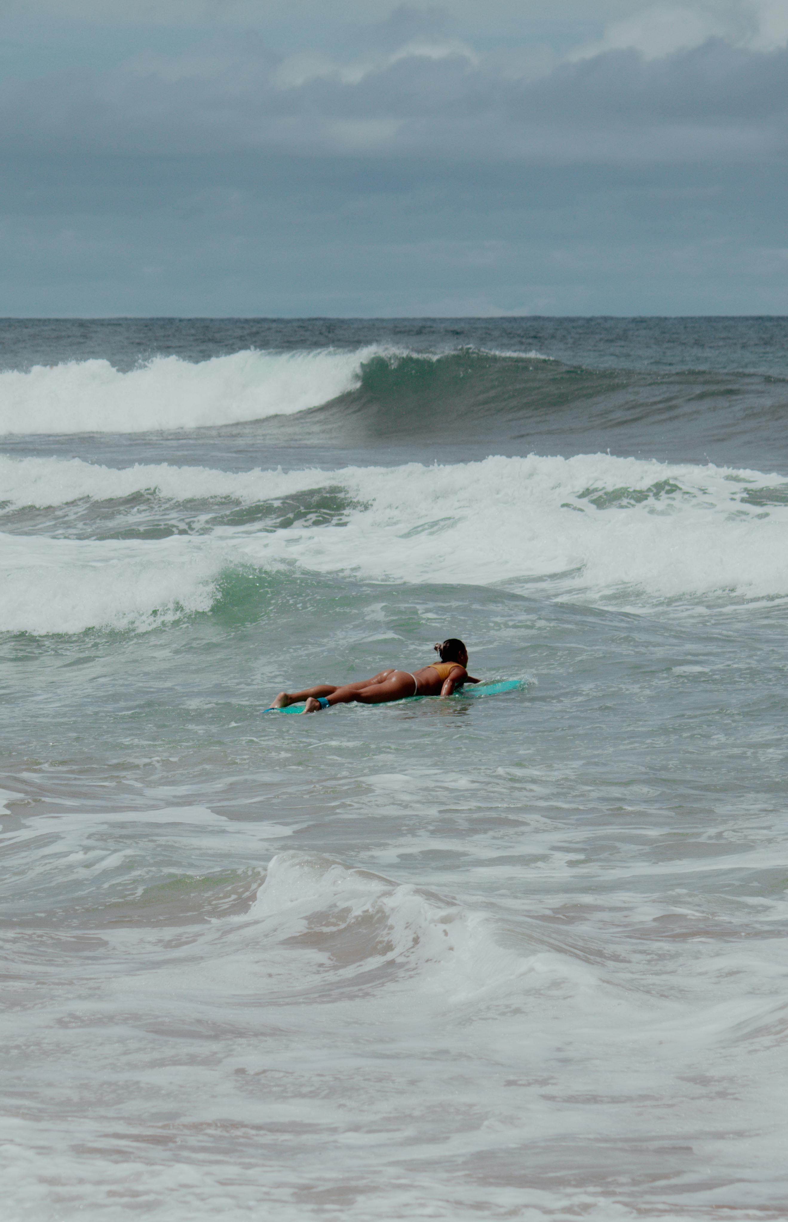 a person riding a surfboard in the sea