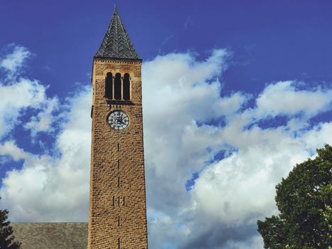 Brown Concrete Tower Under Blue Sky and White Clouds