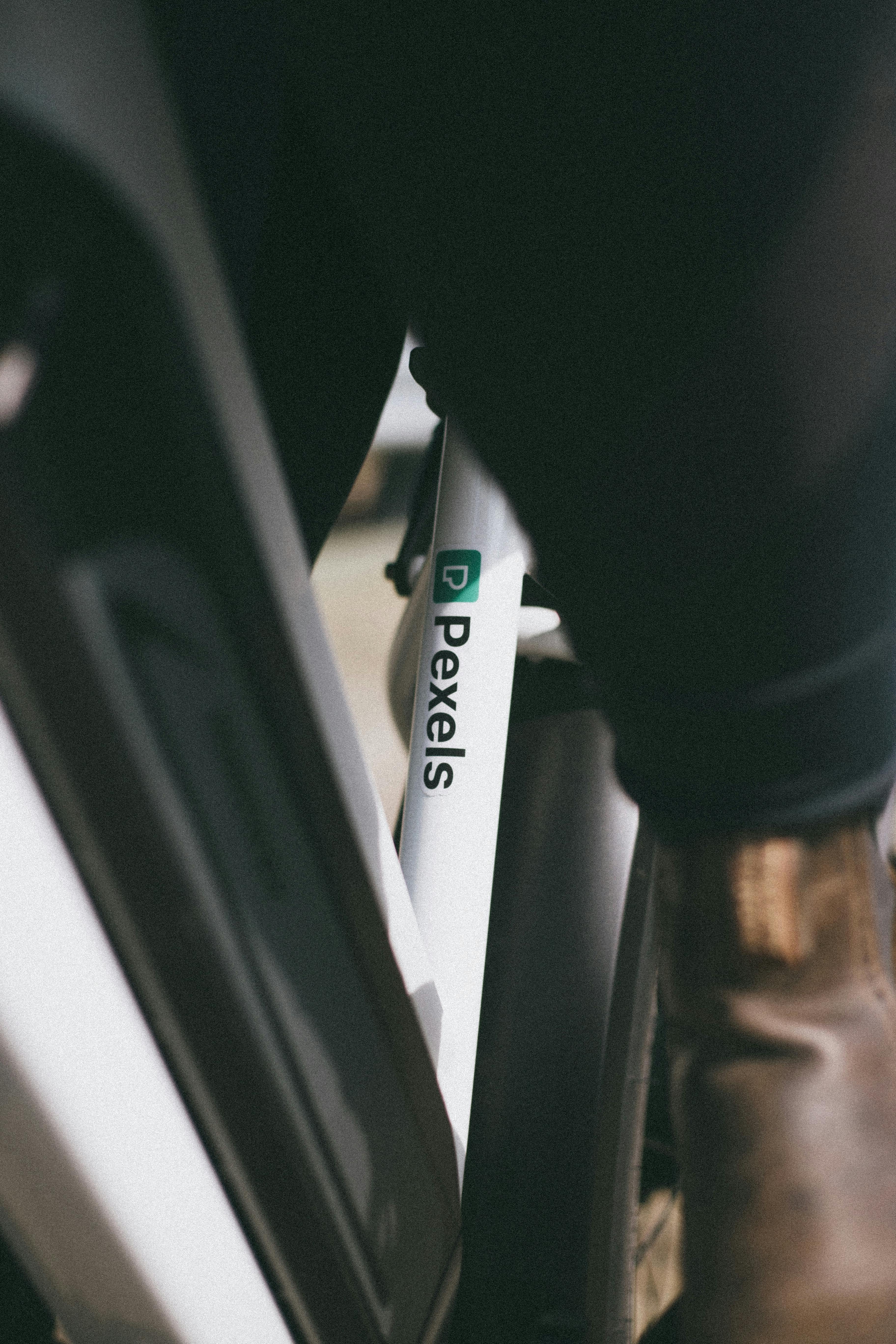 Detailed shot of a bicycle frame featuring the Pexels logo with focus on texture and design.